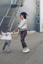 Cheerful mother and daughter having fun in city