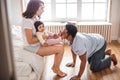 Cheerful a mother hugging her son and father kissing his toes Royalty Free Stock Photo