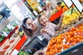 Cheerful mother and little girl choosing fresh fruits Royalty Free Stock Photo