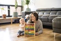 Cheerful mother playing with his baby girl on floor at living room Royalty Free Stock Photo