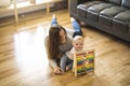 Cheerful mother playing with his baby girl on floor at living room Royalty Free Stock Photo