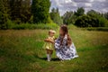 Cheerful mother plays with her little daughter at the green meadow Royalty Free Stock Photo