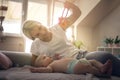 Cheerful mother plying with her little baby boy at home. Royalty Free Stock Photo