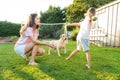 Cheerful mother and son playing with dog, throwing a ball and have fun together. Happy family playing with tennis ball Royalty Free Stock Photo