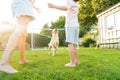 Cheerful mother and son playing with dog, throwing a ball and have fun together. Happy family playing with tennis ball Royalty Free Stock Photo