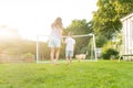 Cheerful mother and son playing with dog, throwing a ball and have fun together. Happy family playing with tennis ball Royalty Free Stock Photo