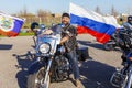 A cheerful motorcyclist with the flag of Russia. The Victory Day is May 9, 2018.