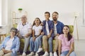 Cheerful multi-age big family watching TV together and enjoying spending time together. Royalty Free Stock Photo