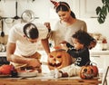 Happy multi ethnic family preparing for Halloween celebration