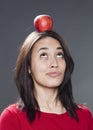 Cheerful multi-ethnic 20s girl playing with apple for fun Royalty Free Stock Photo