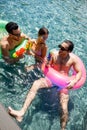 cheerful multicultural friends relaxing in pool