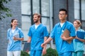 cheerful multicultural medical students walking