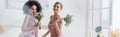 cheerful multicultural women holding wedding bouquets