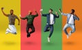 Cheerful multiethnic guys jumping and taking selfie on smartphones over colorful backgrounds Royalty Free Stock Photo