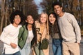 Cheerful multiethnic teenagers embracing and smiling at camera outdoors Royalty Free Stock Photo