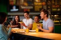 Cheerful multiracial friends having fun eating in pizzeria. Royalty Free Stock Photo