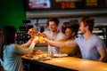 Cheerful multiracial friends having fun eating in pizzeria. Royalty Free Stock Photo