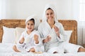 Cheerful mummy and kid drinking tea, eating cookies