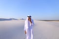 Young male emirate rejoices in life and walks through expanses o