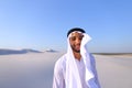 Young male emirate rejoices in life and walks through expanses o