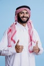 Muslim man in thobe showing thumbs up