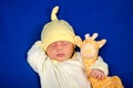 Cheerful newborn baby boy sleeping on a blue blanket with little toy Royalty Free Stock Photo