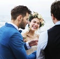 Cheerful newlyweds at beach wedding ceremony Royalty Free Stock Photo