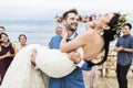 Cheerful newlyweds at beach wedding ceremony Royalty Free Stock Photo