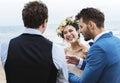 Cheerful newlyweds at beach wedding ceremony Royalty Free Stock Photo