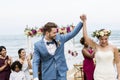 Cheerful newlyweds at beach wedding ceremony Royalty Free Stock Photo