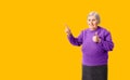 Cheerful octogenarian woman showing on empty place for copy space. Royalty Free Stock Photo