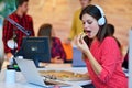 Cheerful office girl enjoying pizza at lunchtime