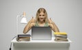 Cheerful office worker business student woman freelancer showing two thumbs up in front of laptop while speaking with a Royalty Free Stock Photo