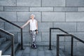 Cheerful old lady relaxing after exercise on granitical stairs outdoors Royalty Free Stock Photo