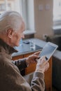 Positive Senior using Digital Tablet Royalty Free Stock Photo