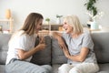 Cheerful old mother and young adult daughter talking laughing to Royalty Free Stock Photo