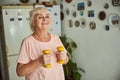 Cheerful old woman doing exercise with dumbbells at home Royalty Free Stock Photo