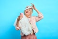 Cheerful old woman holding disposable plasic cup of tee Royalty Free Stock Photo