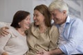 Cheerful older couple of parents and daughter meeting at home Royalty Free Stock Photo