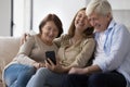 Cheerful older couple of parents and daughter meeting at home Royalty Free Stock Photo