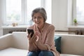 Cheerful older grandma woman talking on video call Royalty Free Stock Photo