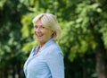 Cheerful older woman smiling outdoors