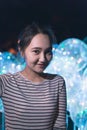 Cheerful optimistic asian girl smiling, neon light background