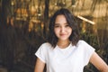 Cheerful optimistic asian girl in a white t-shirt, smiling