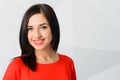 Cheerful optimistic confident brunette girl dressed in red with perfect smile