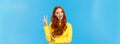 Cheerful outgoing and happy charismatic redhead female in yellow sweater, showing peace sign, number two or twice and