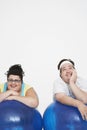 Cheerful Overweight Couple Resting On Exercise Balls Royalty Free Stock Photo