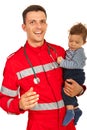 Cheerful paramedic holding baby