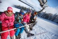 Parents with children in ski lift lifting on ski terrain Royalty Free Stock Photo