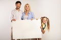 Cheerful Parents And Daughter Holding Blank Board, White Background Royalty Free Stock Photo